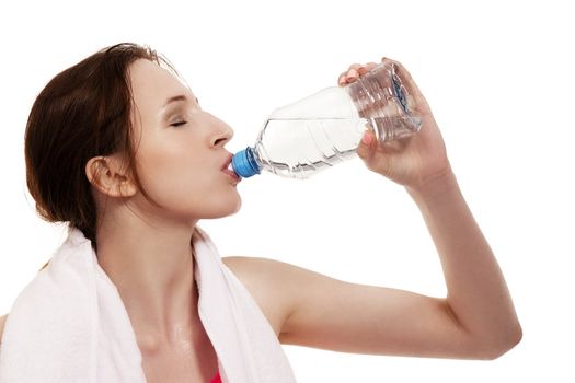 young sporty woman drinking water on white background