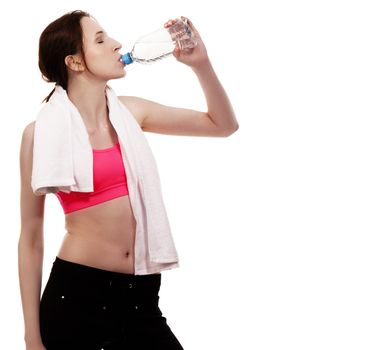 young sporty woman drinking water on white background