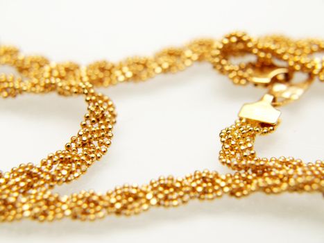 Yellow gold jewellry, isolated towards white background