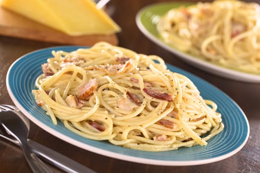 Spaghetti alla Carbonara made with bacon, eggs, cheese and black pepper (Selective Focus, Focus one third into the meal)