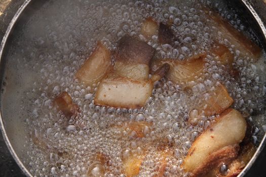 Fat meat boiling in the big saucepan