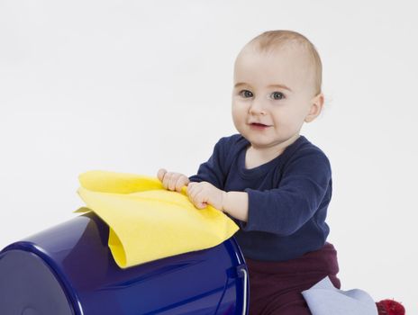 toddler with bucket and floor cloth in grey background