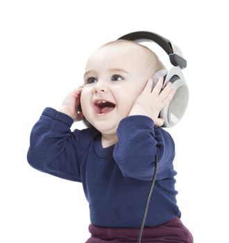 young child with earphones listening to music. isolated on white background