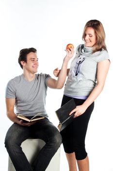 Young students - a boy and a girl reading a book and prepare for exams