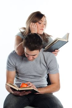 Young students - a boy and a girl reading a book and prepare for exams