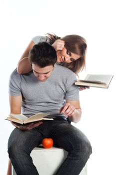 Young students - a boy and a girl reading a book and prepare for exams