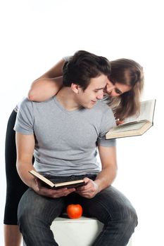 Young students - a boy and a girl reading a book and prepare for exams