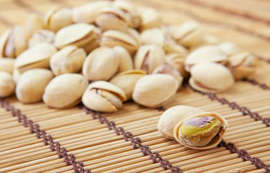 Dried pistachios on a white background