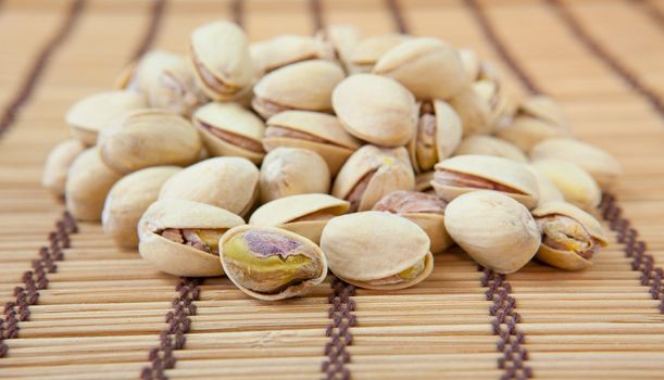 Dried pistachios on a white background