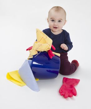 toddler with bucket and floor cloth in grey background