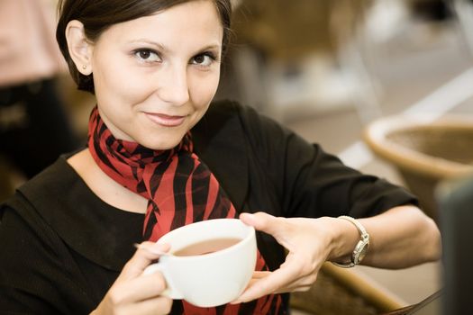 An image of a young woman with a big cup of tea