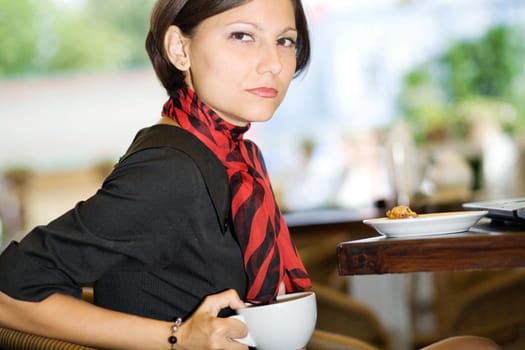 An image of a young woman with a big cup of tea