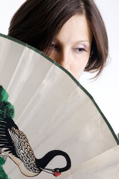 An image of a young woman with a fan