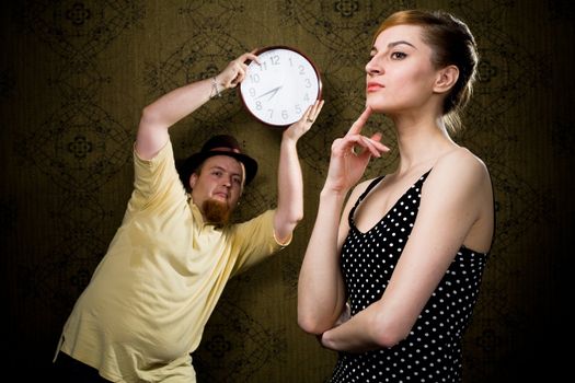 An image of a man with a clock and a nice woman