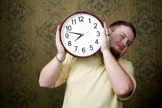 An image of a man with a big clock in his hands