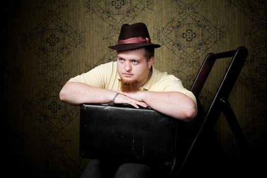 An image of a man with a black valise