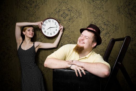 An image of man and woman with a clock