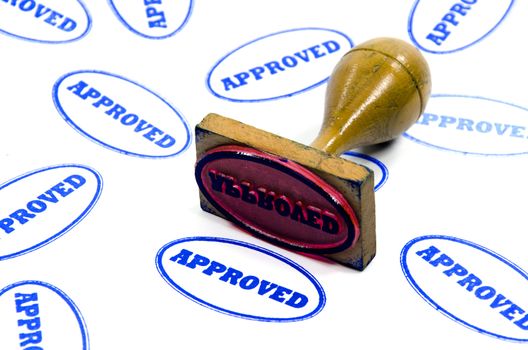 Wood-handled stamp printed on white paper approved
