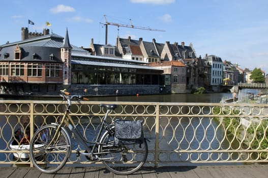 urban landscape in Belgium, view from the bridge, vintage bicycle in the foreground