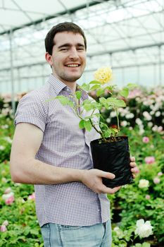 An image of a man with a flower in his hands