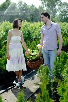 An image of a young couple with a basket with roses