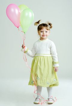 A portrait of a nice little girl with three balloons