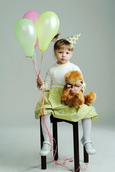 An image of a portrait of a little girl with teddy-bear