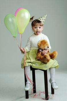 An image of a portrait of a little girl with teddy-bear