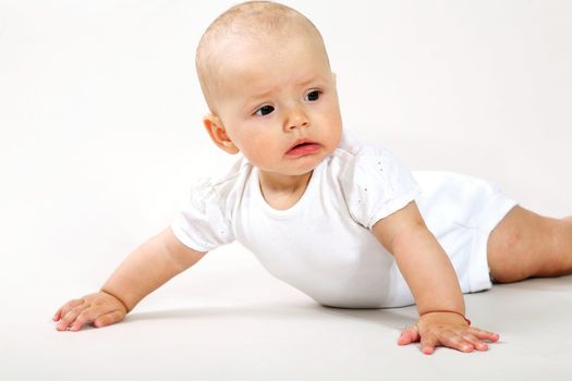 An image of a little baby  crawning in studio