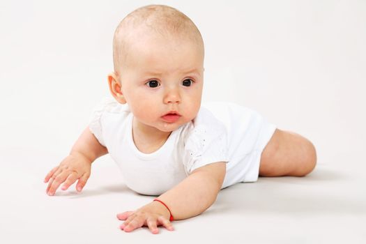 A little baby crawling on the floor
