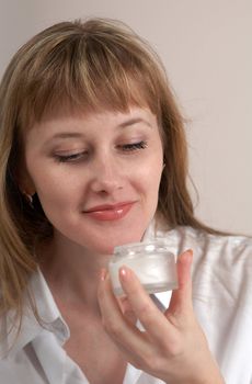A girl in shirt with cream for make-up