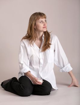 An image of nice girl sitting on neutral background