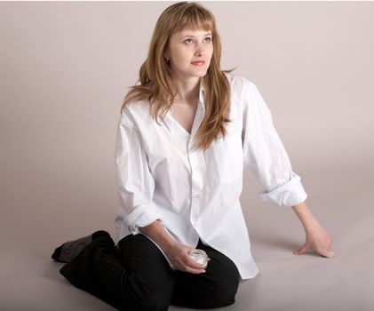 An image of nice girl sitting on neutral background