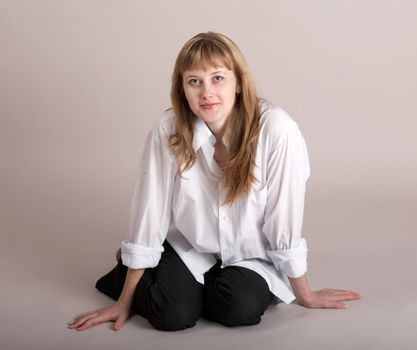 An image of nice girl sitting on  background in studio