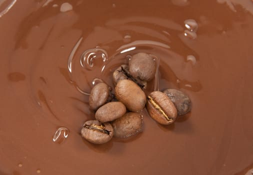 Coffee beans lying on a bed of chocolate