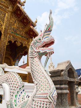 A white stucco naga in Wat Baan Den in Chiang Mai, Thailand, traditional lion, guardian, symbol of power and descendant.