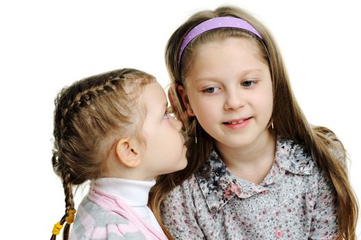 An image of a girl telling a secret to her sister