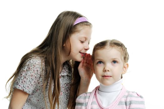 An image of a girl telling a secret to her sister