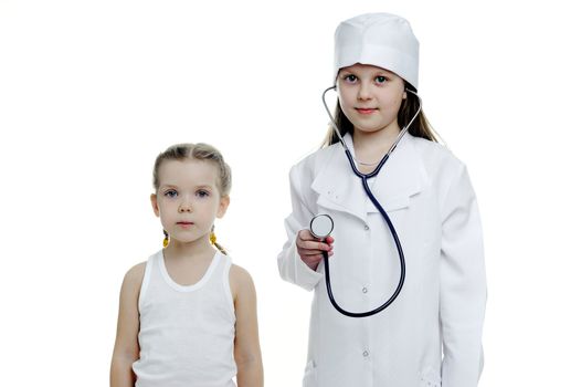 An image of two little girls playing doctors