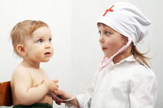 Stock photo: an image of a little doctor examining little patient