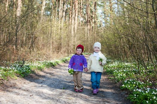 An image of two little girls in the forest