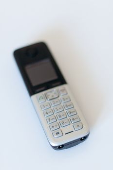 Close Up of Modern Cordless Black and Silver DECT Phone on White Background