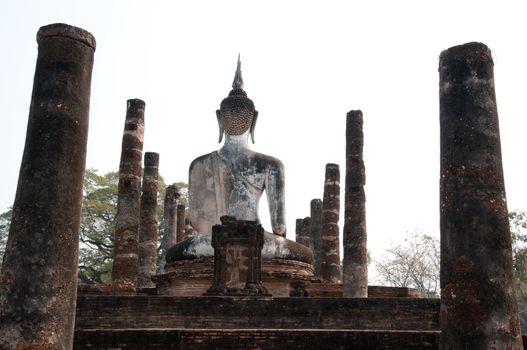 Back of Buddha Sculpture  in Wat Mahathat Temple in Sukhothai Historical park at sunset, Thailand.