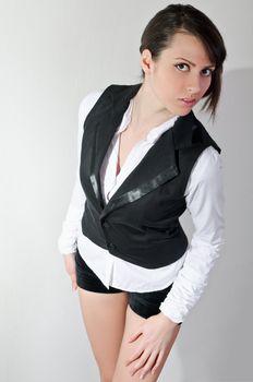 fashion shot of Beautiful girl in black vest and shorts with seducive expression, above angle