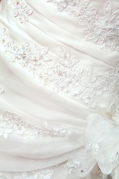 part of the white wedding dress with artificial flowers