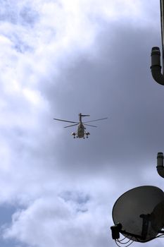 view of a sea rescue helicopter flying past a house