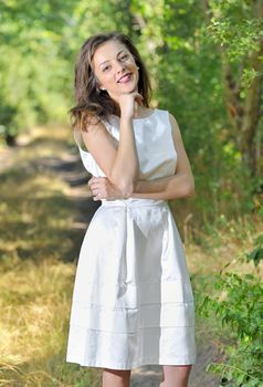 beauty girl in a fashioned dress in a forest