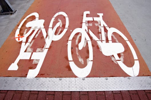 bicycle track signs on pavement in the city