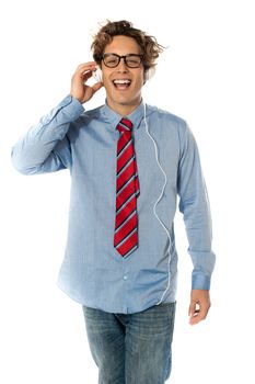 Young man listening to music isolated