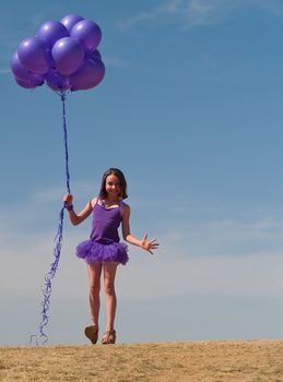 Pretty little girl with baloons in hand